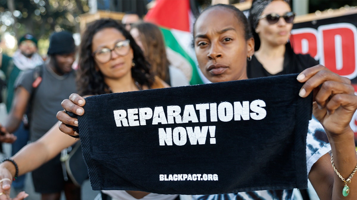People supporting reparations holding sign