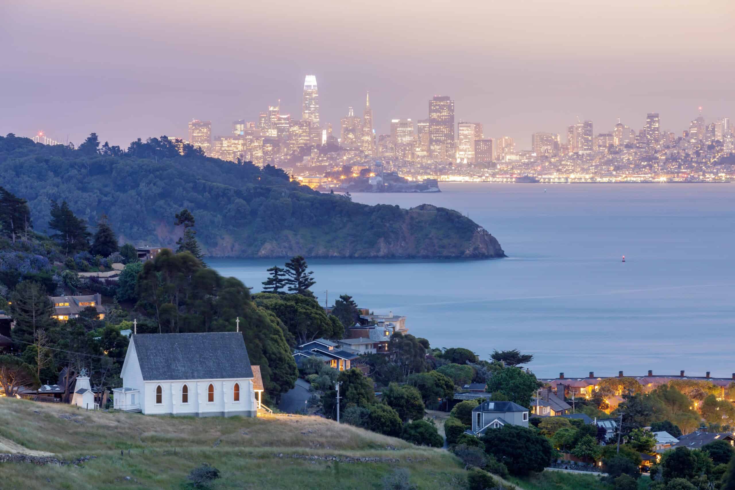 Marin County, California | Scenic views of Old St Hillary's Church, Angel Island, Alcatraz Prison, San Francisco Bay and San Francisco Skyline at dusk.
