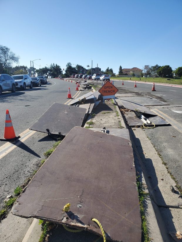 Boards and planks cover a median on Soledad Mountain Road during a project to replace underground pipes. (Ashley Mackin-Solomon)