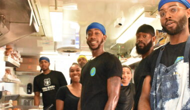 people posing for a photo inside a food truck