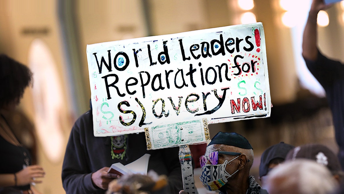 A pro-reparations sign held up at meeting