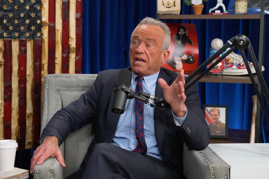 RFK Jr. speaking into a microphone while seated on a podcast set.