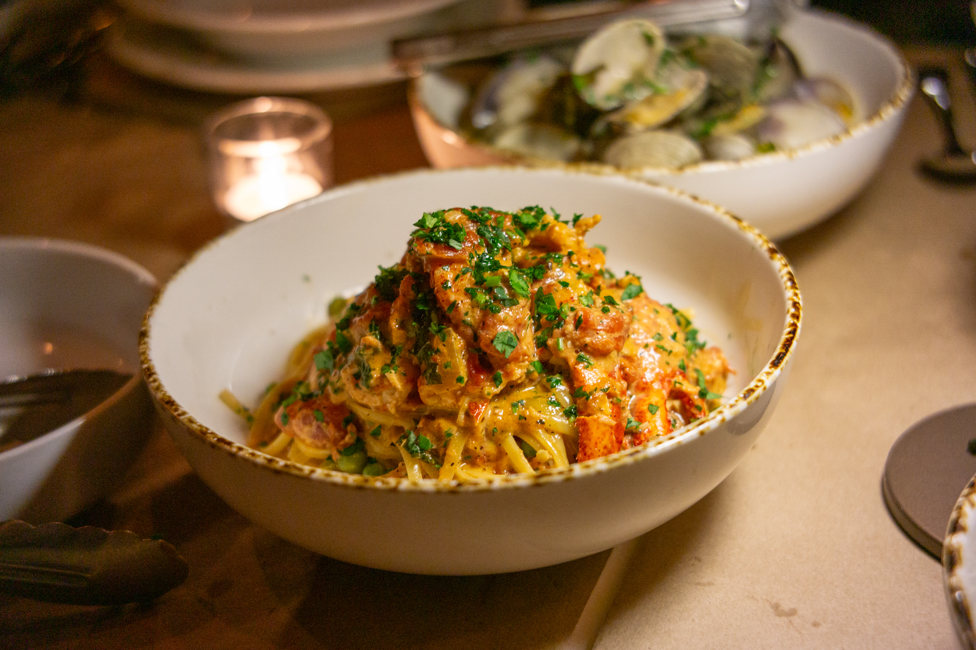Bowl of linguine covered in sauce with lobster claws at Sal’s Place.