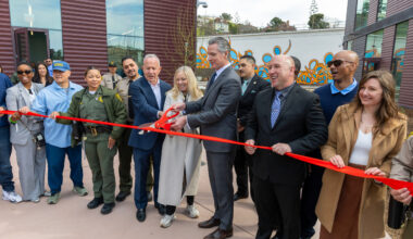 A photo of Governor Newsom and others cutting a ribbon at the San Quentin Learning Center