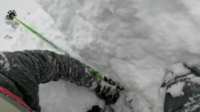 Schmidt and his friend free the man's face from feet of snow so he can breathe.