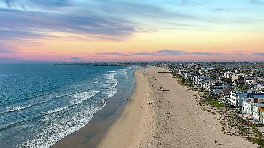 Cars driving on the street and blue sky with clouds in Huntington Beach, California.