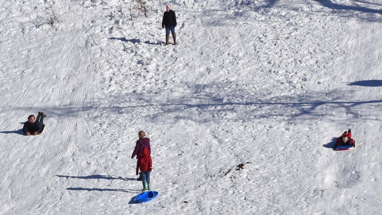 Sledders wore smooth, slippery paths down the hills, resulting in high speed fun.