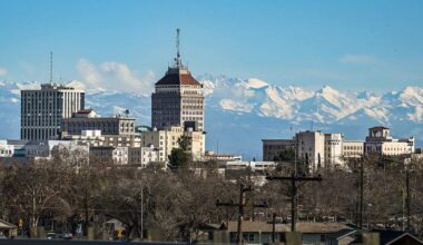 Fresh snow covers the Sierra Mountains east of downtown Fresno’s skyline on a clear day on Tuesday, Jan. 6, 2026. A wave of storms moved through Central California and the mountains over the holidays pushing the region’s precipitation numbers past normal for this time of year.