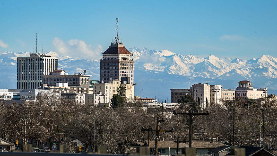 Fresh snow covers the Sierra Mountains east of downtown Fresno’s skyline on a clear day on Tuesday, Jan. 6, 2026. A wave of storms moved through Central California and the mountains over the holidays pushing the region’s precipitation numbers past normal for this time of year.