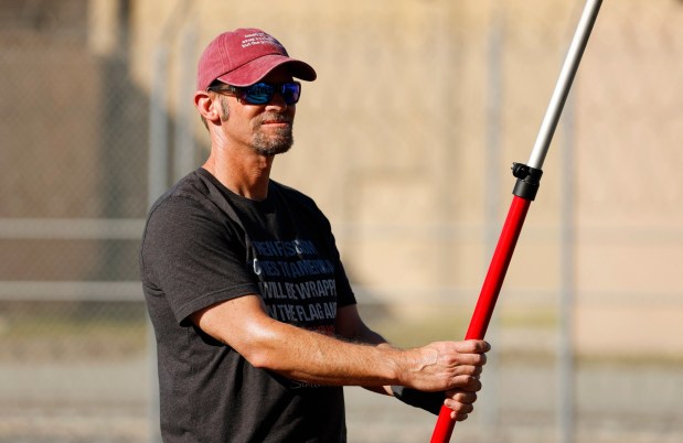 Jon Bachelor holds an American flag at a weekly vigil for people arrested by Immigration and Customs Enforcement at its Otay Mesa detention center on Feb. 1, 2026. (K.C. Alfred / The San Diego Union-Tribune)