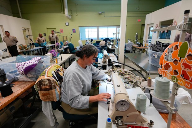 A woman incarcerated at the Las Colinas Detention and Reentry Facility works in the sewing department on Wednesday, Jan. 28, 2026. (Nelvin C. Cepeda / The San Diego Union-Tribune)