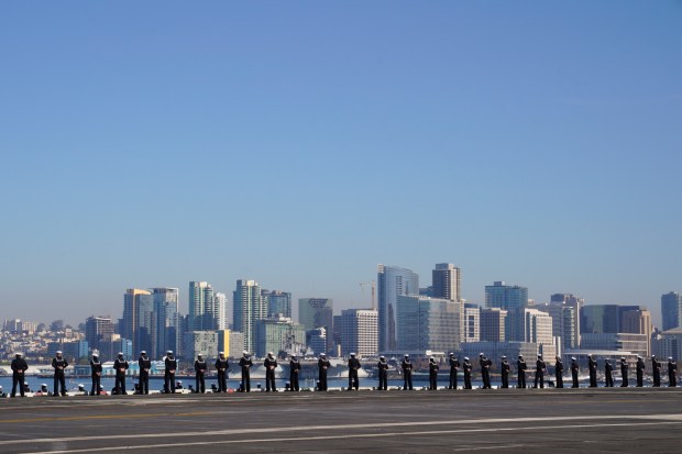 Sailors on board the USS Abraham Lincoln (CVN-72) man the rails on their return to San Diego and NAS Coronado on Friday, Dec. 20, 2024, in Coronado, CA. (Nelvin C. Cepeda / The San Diego Union-Tribune)