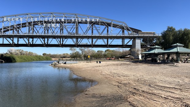 The historic Ocean to Ocean Highway Bridge spans over the Colorado River at Yuma Beach in Gateway Park in Yuma. (Kristina Davis / The San Diego Union-Tribune)