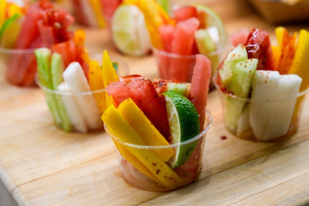 Chefs at Snapdragon prepared fresh mango, watermelon, jicama, cucumber, Tajin, chamoy, and lime to create Baja Street Fruit Cups.  (Nelvin C. Cepeda / The San Diego Union-Tribune)