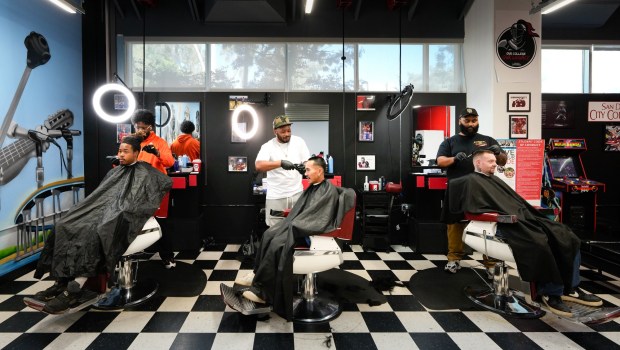 One of the new programs Ricky Shabazz, president of San Diego City College, put in place is a free barber shop at San Diego City College on Tuesday, Feb. 3, 2026, in San Diego.  The program is primarily for men, who can receive a free haircut while learning about the school resources available to them to help towards graduating.  Students Chasan Haynes, Elvis To, and Mike Patke are pictured from left to right in the front row. Left-to-right back row, barber Larry Jackson. Synod Mitchell and Stephen Williams.  (Nelvin C. Cepeda / The San Diego Union-Tribune)