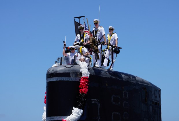 Cmdr. Chris Rose (c), Alexandria's commanding officer, was among the sailors on the conning tower as the USS Alexandria pulled into Naval Base Point Loma on Thursday, May 15, 2025, in San Diego, CA. USS Alexandria returns to Naval Base Point Loma after a 7-month deployment in the Pacific. (Nelvin C. Cepeda / The San Diego Union-Tribune)