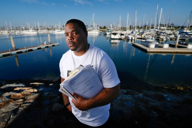 Holding his court files, Frank Heard is at one of his favorite places, the Bayfront Park in Chula Vista, CA.  Frank Heard, 36, was released after serving 18 years in prison for a conviction he received as a juvenile. His legal petition was granted, and his case set a precedent regarding decades-long sentences for juveniles. .. (Nelvin C. Cepeda / The San Diego Union-Tribune)