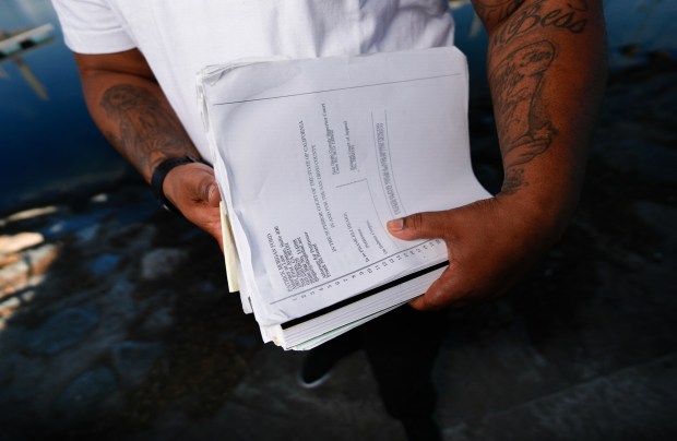 Holding his court files, Frank Heard is at one of his favorite places, the Bayfront Park in Chula Vista, CA.  Frank Heard, 36, was released after serving 18 years in prison for a conviction he received as a juvenile. His legal petition was granted, and his case set a precedent regarding decades-long sentences for juveniles. .. (Nelvin C. Cepeda / The San Diego Union-Tribune)