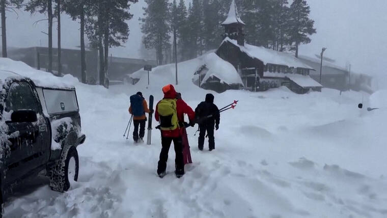 NEVADA COUNTY SHERIFFS OFFICE/HANDOUT VIA REUTERS
                                A rescue team departs for the site of an avalanche on a backcountry slope of Californias Sierra Nevada mountains, where a group of skiers was stranded, in Nevada County, Calif., today, in this still image from a video.