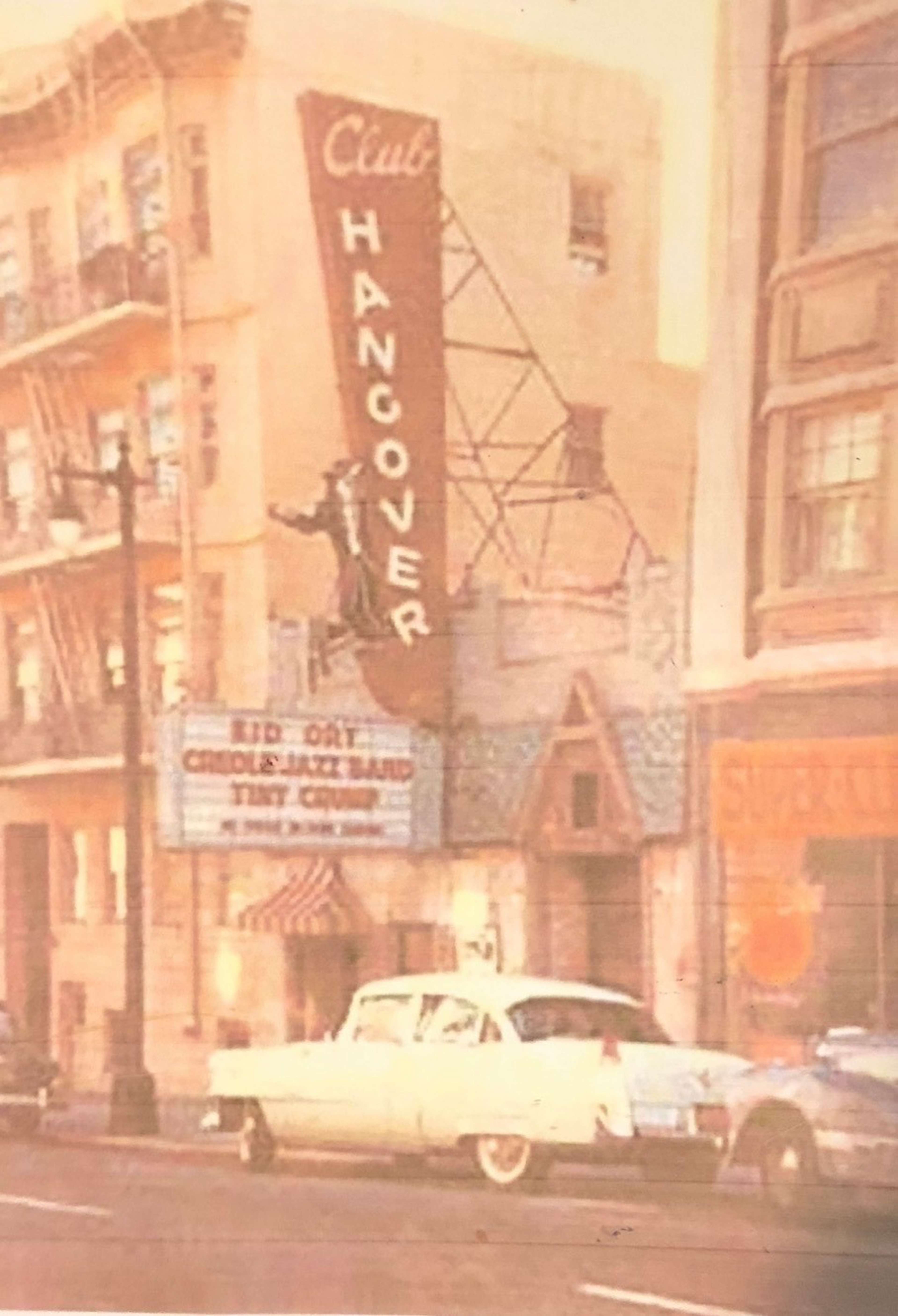 A vintage white car is parked in front of Club Hangover, a music venue with a vertical sign and a marquee announcing a Creole jazz band and Tiny Grimes.