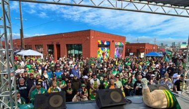 The view from the stage at a large outside gathering of sports fans.