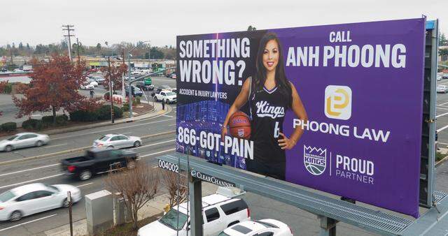 Vehicles drive past one of attorney Anh Phoong’s ubiquitous billboards, emblazoned with her “Something wrong?” tagline and touting her connection with the Sacramento Kings, on Arden Way in 2024.