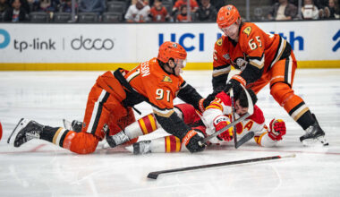 Mar 1, 2026; Anaheim, California, USA; Anaheim Ducks center Leo Carlsson (91) and Anaheim Ducks defenseman Jacob Trouba (65) with Calgary Flames center Nazem Kadri (91) during the third period at Honda Center. Mandatory Credit: Corinne Votaw-Imagn Images