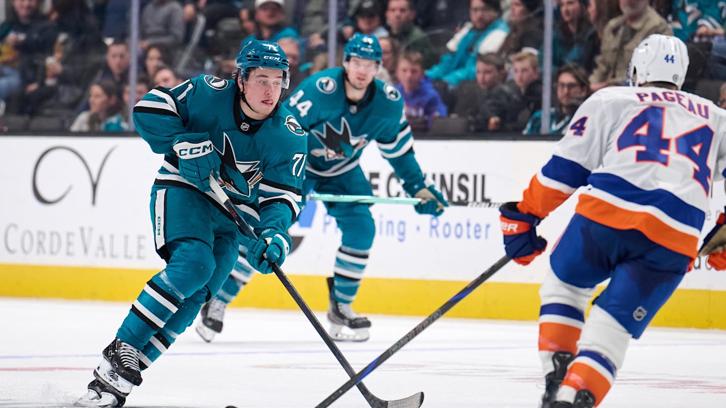 Mar 8, 2025; San Jose, California, USA; San Jose Sharks center Macklin Celebrini (71) plays the puck against New York Islanders center Jean-Gabriel Pageau (44) during the second period at SAP Center at San Jose. Mandatory Credit: Robert Edwards-Imagn Images