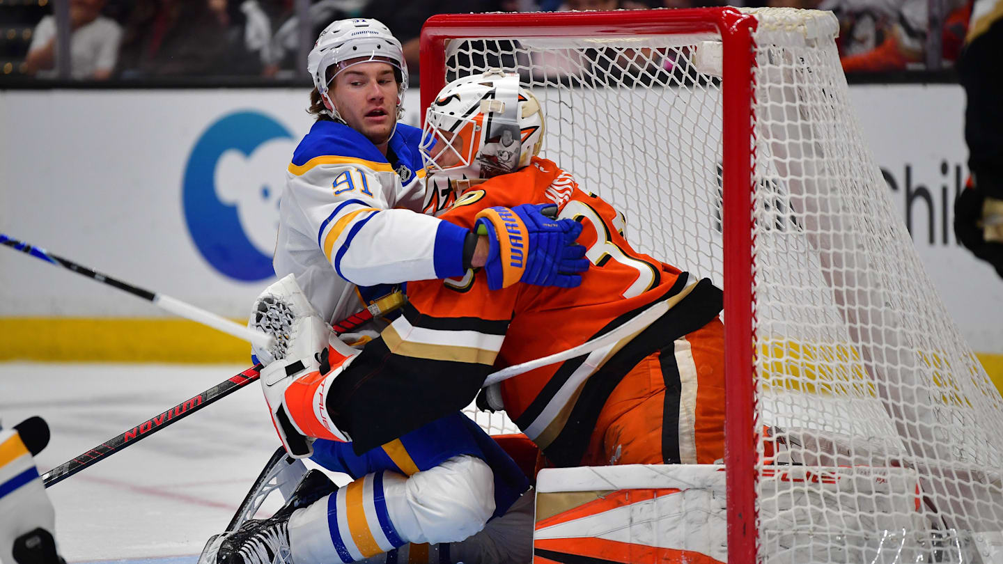 Mar 22, 2026; Anaheim, California, USA; Buffalo Sabres right wing Josh Doan (91) collides with Anaheim Ducks goaltender Ville Husso (33) during the first period at Honda Center. Mandatory Credit: Gary A. Vasquez-Imagn Images