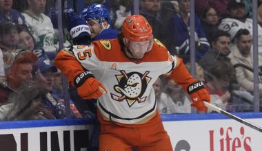 Mar 12, 2026; Toronto, Ontario, CAN; Anaheim Ducks defenseman Jacob Trouba (65) checks Toronto Maple Leafs defenseman Oliver Ekman-Larsson (95) into the boards during the first period at Scotiabank Arena. Mandatory Credit: John E. Sokolowski-Imagn Images