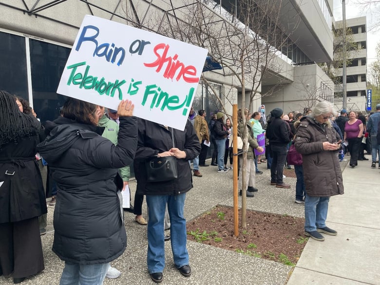 Department of Fish and Wildlife employee Nikolette Clavel holds a sign at a protest against Newsom’s return to the office mandate. March 12, 2025