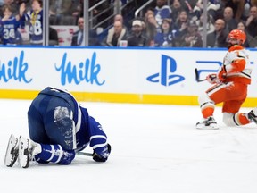 Maple Leafs captain Auston Matthews (34) lies on the ice after getting injured by Anaheim Ducks defenceman Radko Gudas.