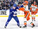 Toronto Maple Leafs' Michael Pezzetta (61) fights with Anaheim Ducks Jeffrey Viel (28) during a game.