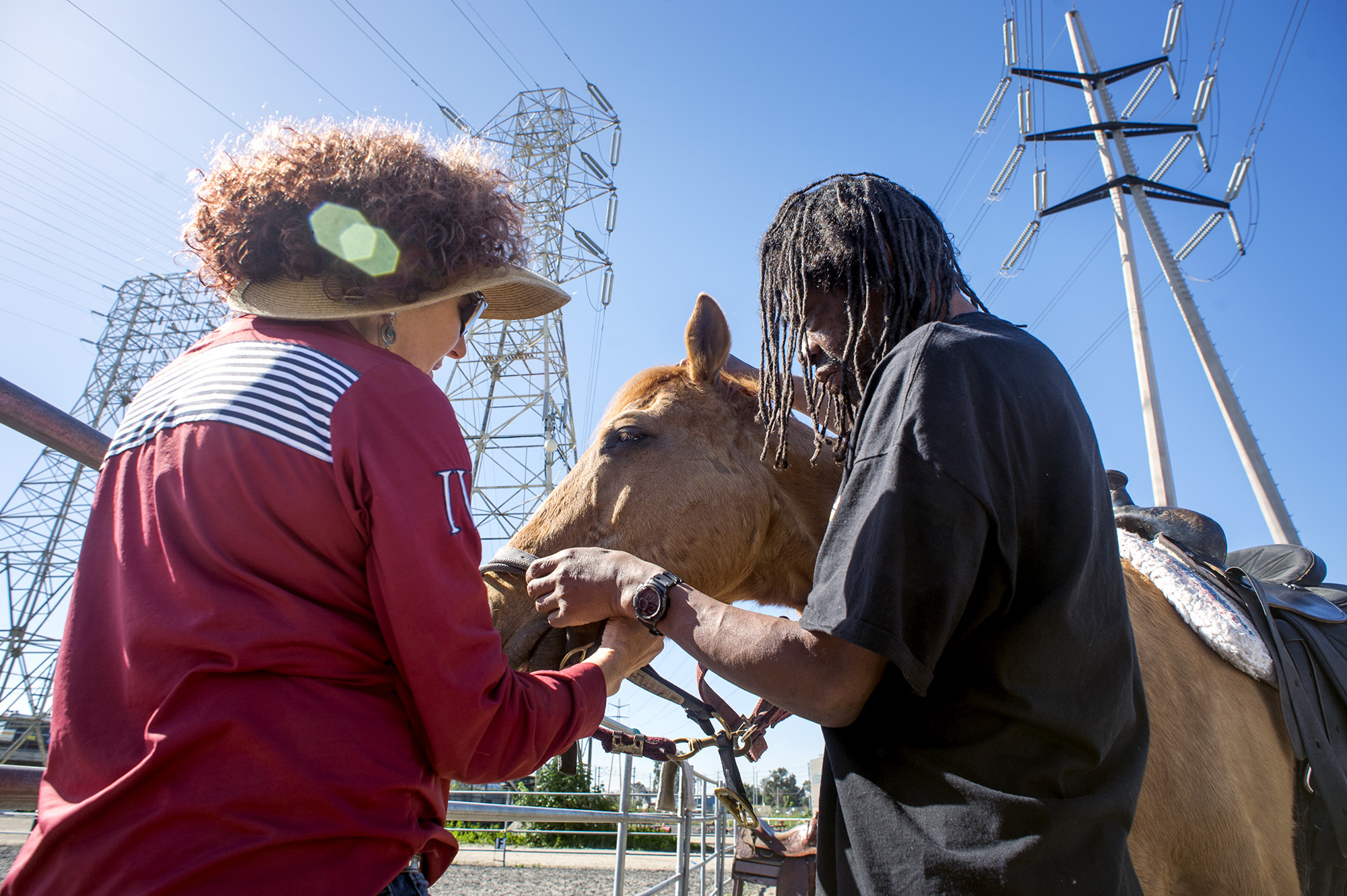 A U.S. Marine Corps veteran receives horsemanship lessons from Joan...