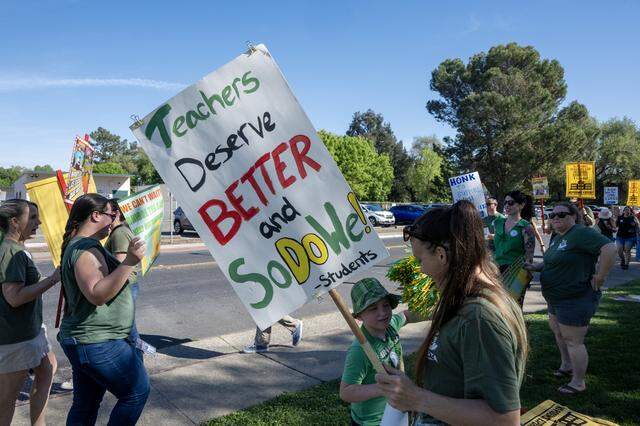 Megan Heringer, PTSA President at Westmore Oaks Elementary School, pickets with teachers and parents outside the Washington Unified School District office in West Sacramento on Tuesday.