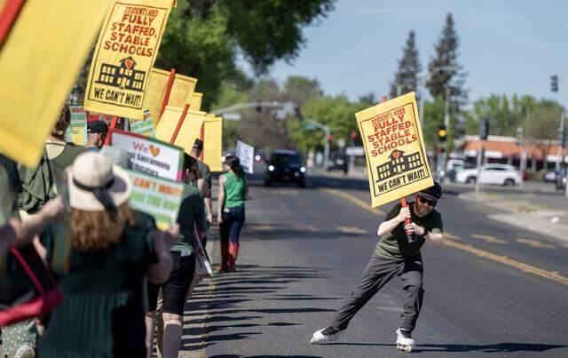 Teachers and supporters rally and picket outside the Washington Unified School District office in West Sacramento on Tuesday.