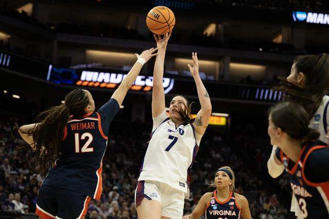 Texas Christian University Horned Frogs forward Marta Suárez shoots over Virginia Cavaliers forward Caitlin Weimar in the first half of a NCAA Women’s Basketball Tournament Sweet 16 game Saturday at Golden 1 Center in Sacramento.