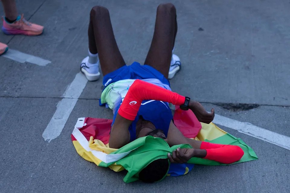 A runner rests on the pavement after finishing the Los Angeles Marathon on Sunday, March 8, 2026, in Los Angeles.