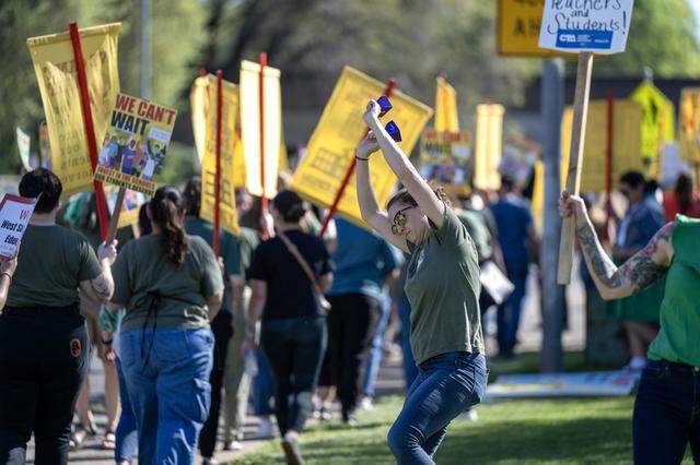 Amanda Angel, a fifth-grade teacher at Stone Gate Elementary School, rings cowbells as teachers and parents picket outside the Washington Unified School District office in West Sacramento on Tuesday.