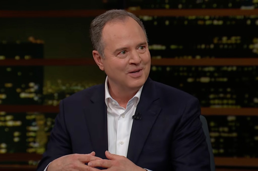 A man in a suit and white shirt, with graying hair, is speaking on a television show.