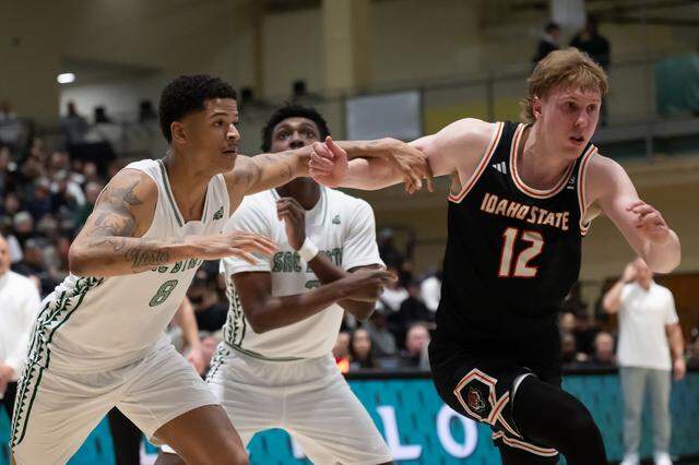 Sacramento State Hornets forward Shaqir O'Neal (8) and Idaho State Bengals guard Lachlan Brewer (12) battle for rebound during a game at Sacramento State on Monday.