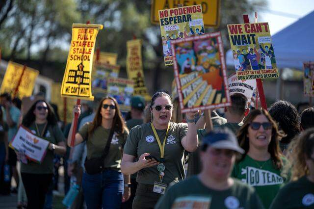 Aisha Johnk, an intervention specialist with the Washington Unified School District, pickets with teachers and supporters outside the district office in West Sacramento on Tuesday.