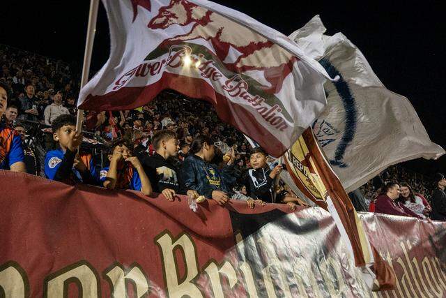 Kids wave the Tower Bridge Battalion flag during the Republic FC’s season-opening match against FC Tulsa on Saturday, March 7, at Heart Health Park in Sacramento.