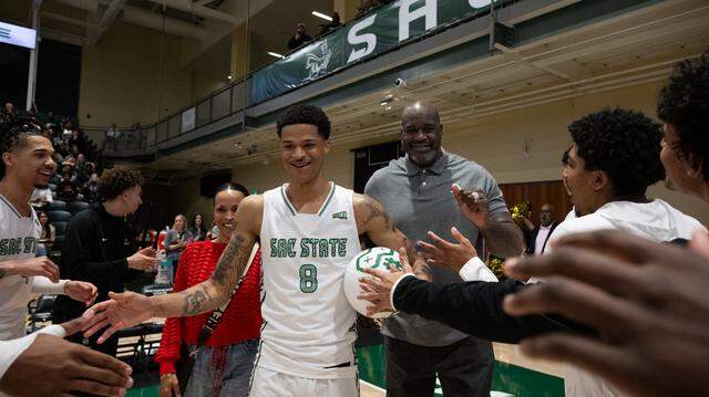 Shaqir O’Neal is joined by his parents, Shaunie Henderson and Shaquille O’Neal, as they walk him onto the court for a pregame ceremony at Sacramento State on Monday.