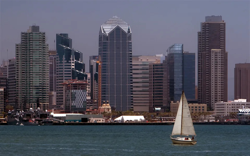 A sailboat cruises past the San Diego skyline in San Diego Harbor on Jun. 15, 2015.