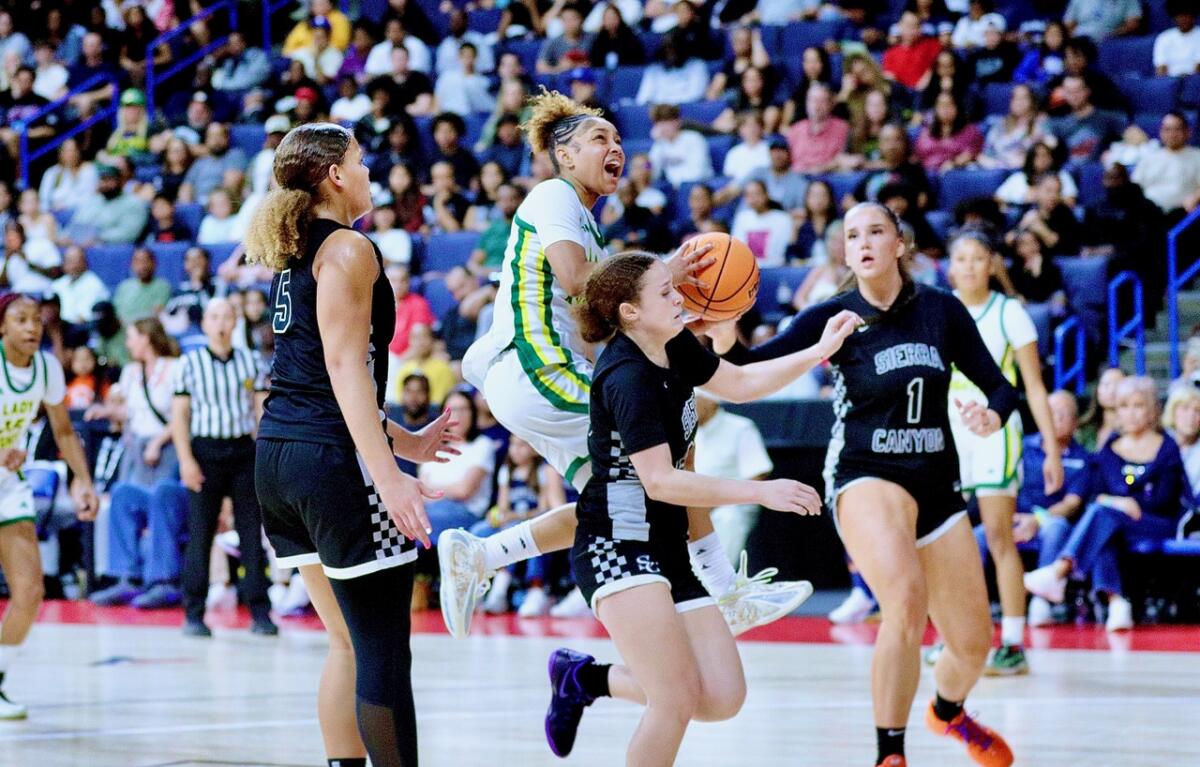 Ontario Christian star Kaleena Smith floats down the lane as she attempts a layup against Sierra Canyon on Saturday night.