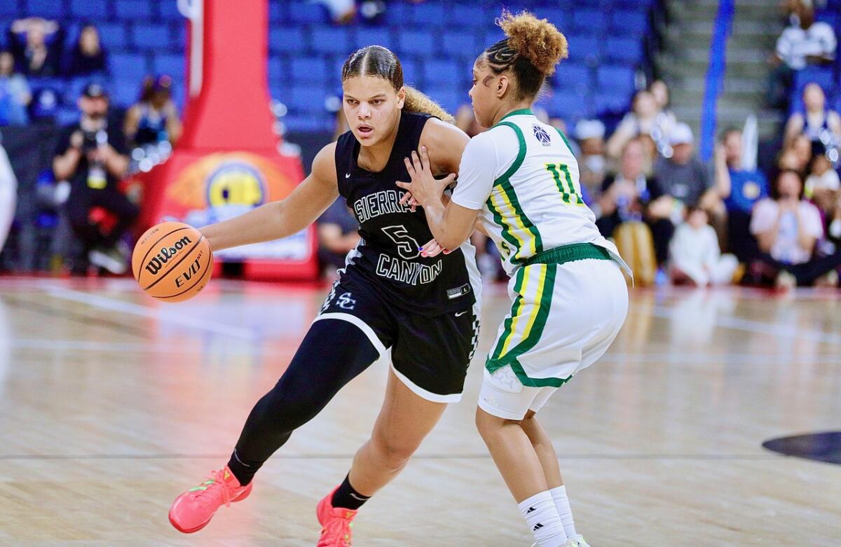 Sierra Canyon’s Jerzy Robinson, left, drives against Ontario Christian’s Kaleena Smith.