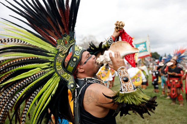 Malinalcoatl, Israel Zabala, blows the conch shell trumpet quiquiztli as dancers enter the ceremonial circle at the 25th Annual Mexica New Year, hosted by Calpulli Tonalehqueh, Azteca Dancers of East San Jose. Over 500 indigenous Danza from across the United States and Mexico participated at Emma Prusch Park in San Jose, Calif., on Saturday, March 11, 2022. The three day ceremony will continue on Sunday, March12, from 9am-5pm at Emma Prusch Park. (Josie Lepe for Bay Area News Group)