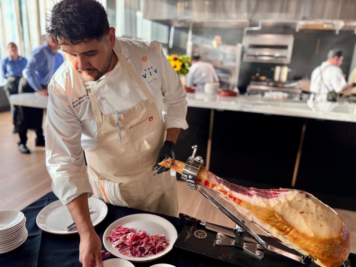 Top of the V Executive Chef Jayro Martinez slices Jamón ibérico, a Spainish style cured leg of pork.