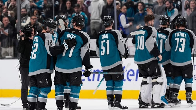 San Jose Sharks center Michael Misa (77) is congratulated by...